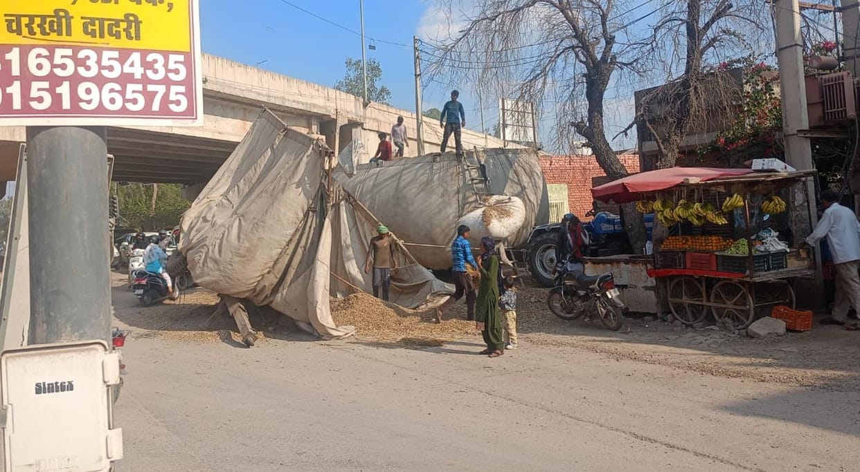 A trolley of wood overturned on Loharu Road in the city.
