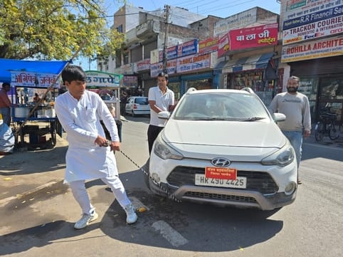 Bad road shown by pulling the car with a rope