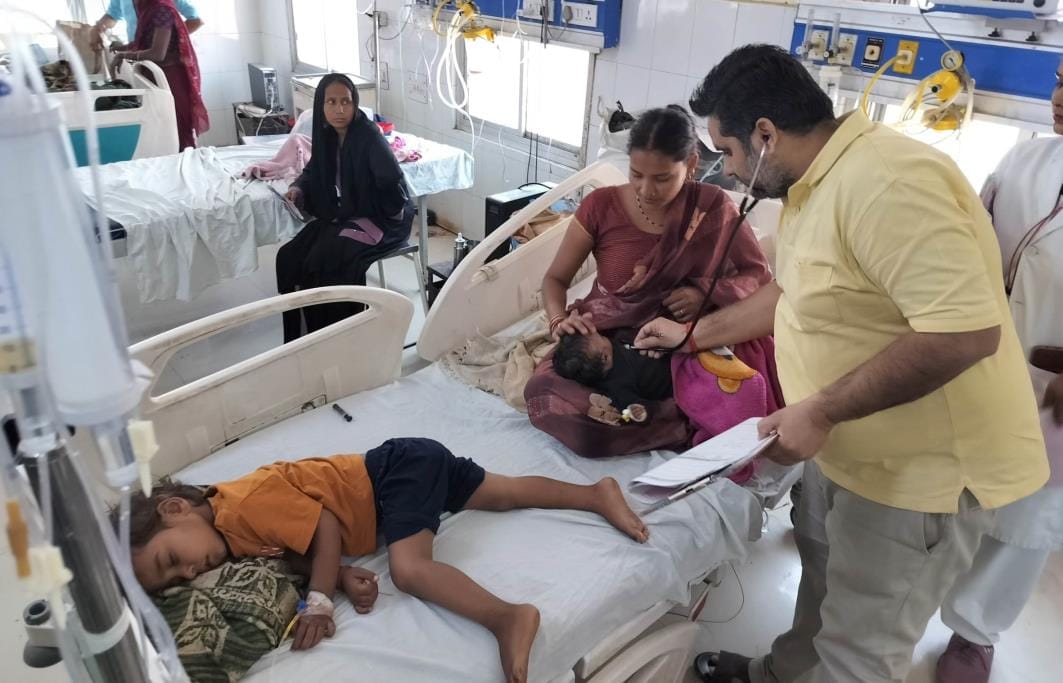 Two children are being treated on one bed