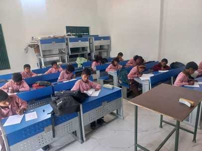 Three students are giving exam on one seat in council schools