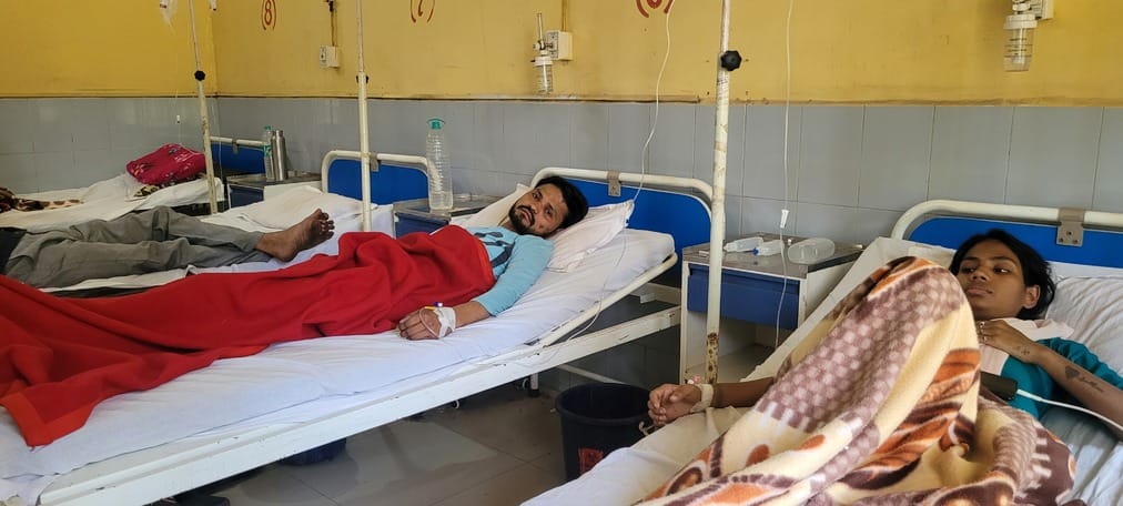 Beds filled with patients suffering from fever and stomach ache