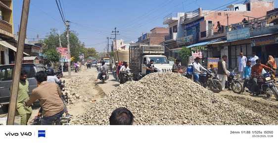 The road was blocked by putting stones during the widening of Tehsil Road, causing a traffic jam