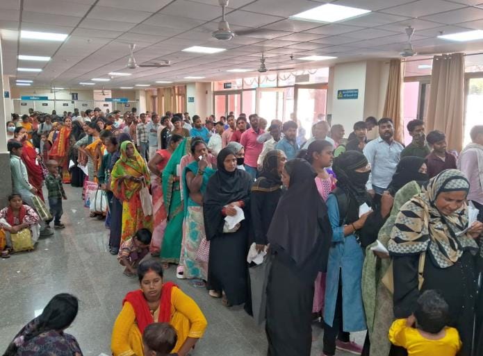 Patients kept waiting sitting on the floor and stairs