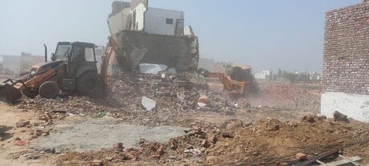 DTP's bulldozer ran on the constructions in the illegal colony near the new bus stand