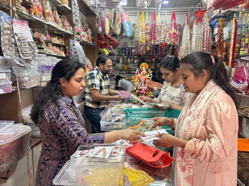 The colourful dress of the mother increased the charm of the market