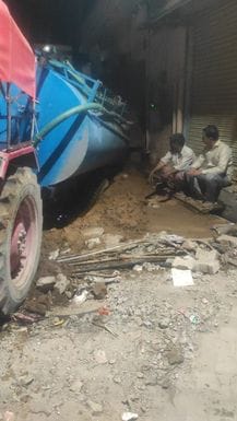 A water tanker got stuck in the road that was broken for construction