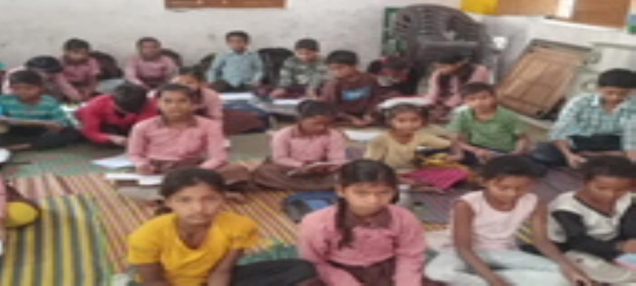 Students of council schools are giving exams sitting on the ground