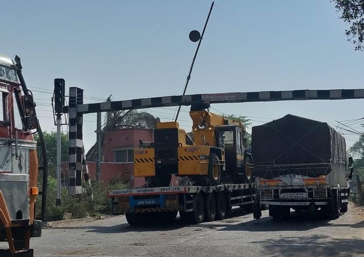 Crane loaded truck stuck in height gauge of Hanumanganj railway crossing