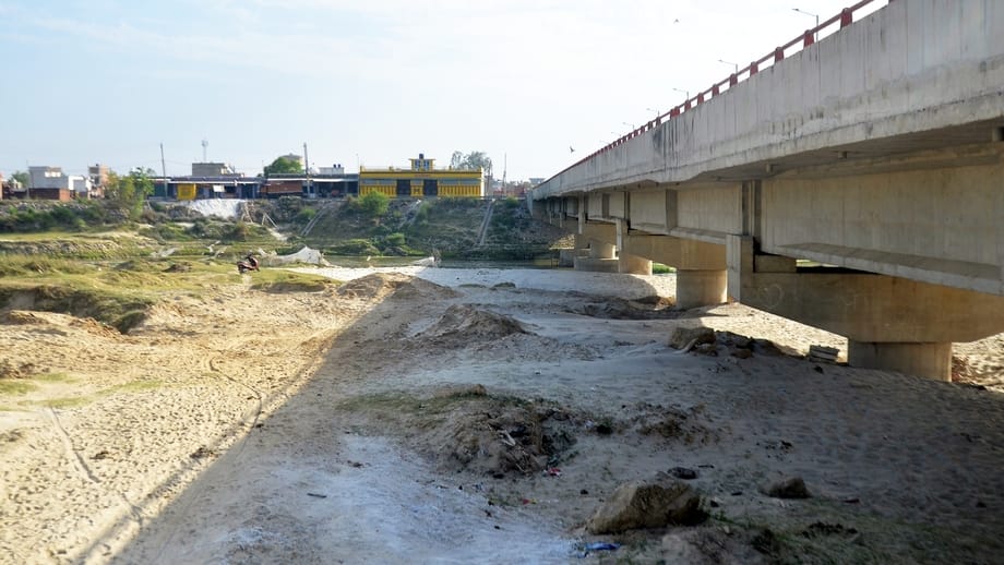 The flow of the Garra river is being affected by the silt deposited on the span of the bridge
