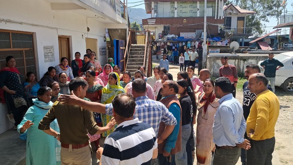 Angry villagers protest outside the police station after a youth was beaten up in Padhar