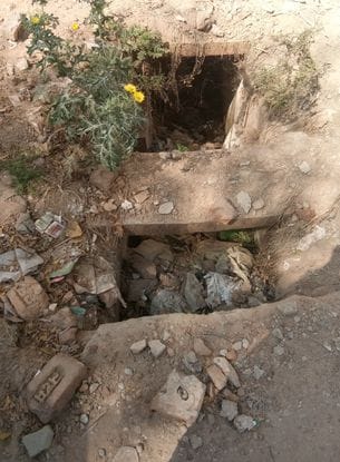 Drains clogged with filth, people covering their noses, responsible eye