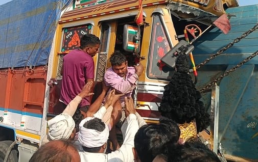 Truck collided with a parked dumper, driver trapped in the cabin