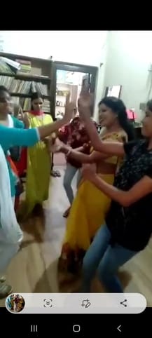 In the upper primary school, Shiksha Mitra is dancing and the children are sweeping