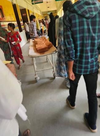 Patients suffer, bricks are carried on stretchers