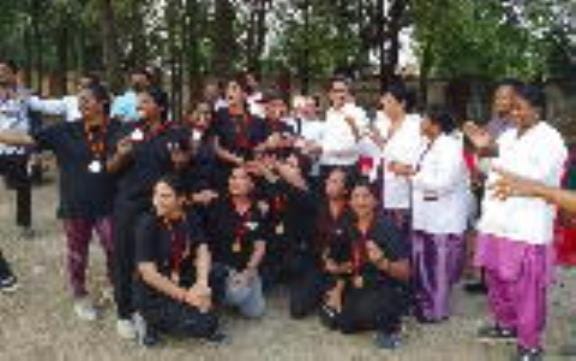 Dr. SP Singh with the winning players in the women's cricket tournament.