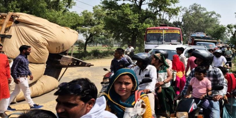 A tractor-trolley loaded with straw overturned on Eta Road, causing a traffic jam
