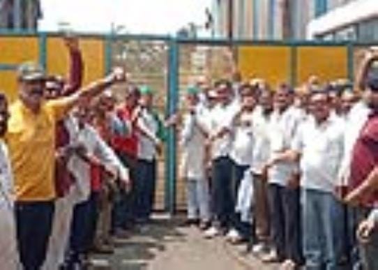 Employees locked the gate of the sugar mill