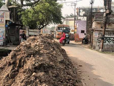 Piles of mud up to half the road, potholes dug everywhere causing pain to pedestrians