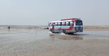 Waterlogging on the river route due to rising water level, vehicles passing through water