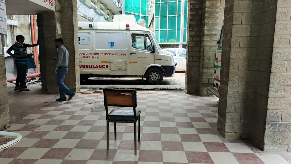 No wheelchair outside the emergency ward, stretcher soaked in rain water