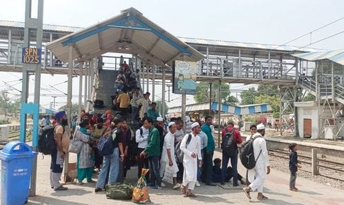 Railway passengers were seen trying to escape the scorching sun...took shelter under the shade of overbridge and trees