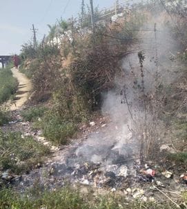 Plastic waste set on fire on railway land