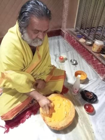 Sevayats are grinding sandalwood for Thakurji