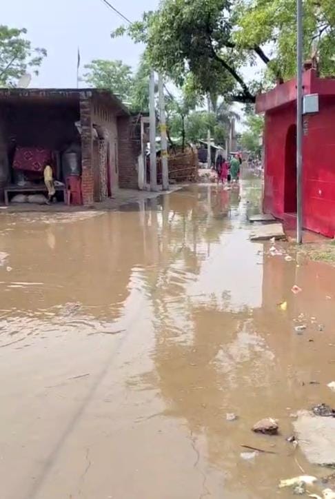 Drain choked, road filled with water due to rain