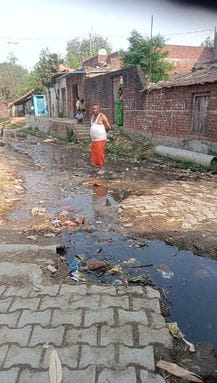 Dirty water from drains filled the roads of Surahi village