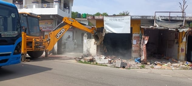 Two shops built on government land in Dhalu village were demolished