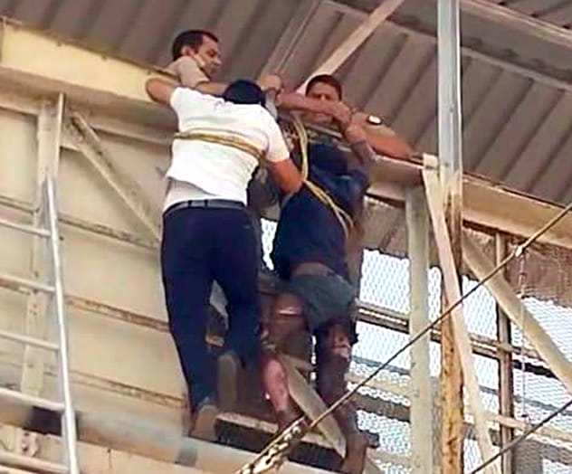 Attempt to commit suicide by jumping from railway overbridge, worker burnt by electric current