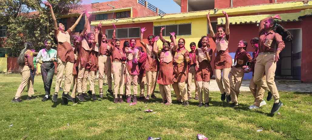 Students celebrated success by throwing gulal