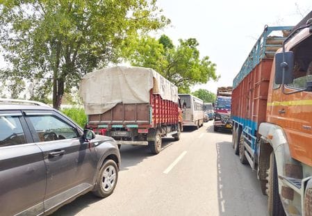 Warehouse's main gate closed, queue of trucks on Safidon-Jind road