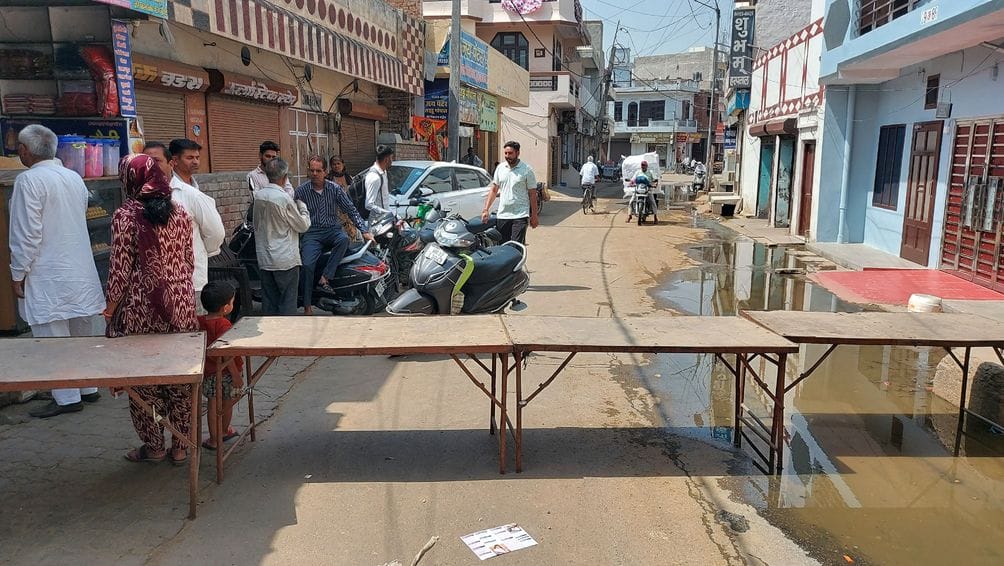 Shopkeepers troubled by sewer overflow, blocked road