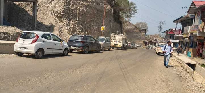 Vehicles are being parked on the side of the under construction NH 03, causing traffic jam