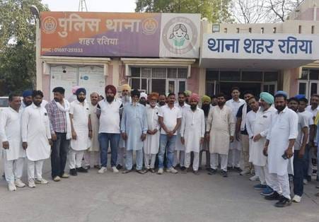 The former Sarpanch and the current Sarpanch of village Bhundwas exchanged shoes and slippers