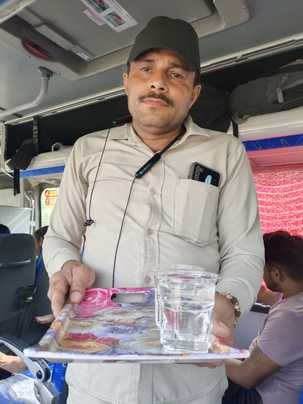 Sukhveer gives water to drink after issuing tickets in buses