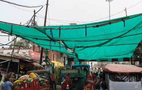 Green sheet roof will protect pedestrians from sun on railway crossing