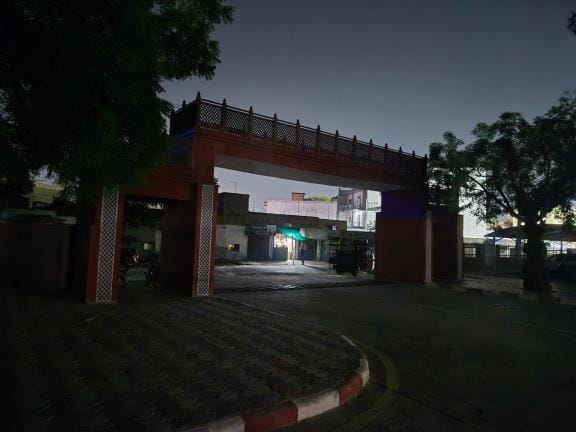 As the evening falls, darkness engulfs the modern railway station, fear of something untoward happening