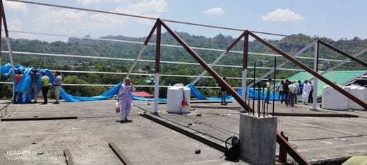 Sandhol Hospital building covered with tarpaulin purchased from donations
