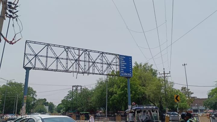 Danger of accidents due to high voltage electricity wire passing along hoarding pole
