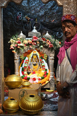 A six feet urn is installed on the main roof of the original Koyla Mata Mandir
