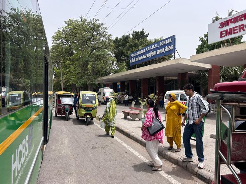 One has to wait for the city bus by standing in the sun, even after four months there is no bus queue shelter
