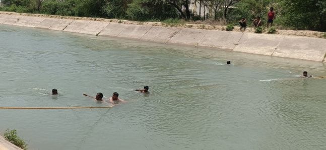 Two youths fell into the canal along with their bike, one was pulled out, the other is being searched