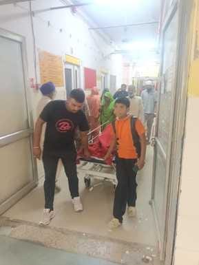 In the district hospital, the attendants themselves pull the patient's stretcher