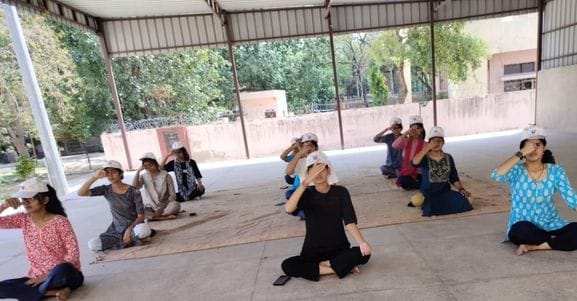 Students and staff practiced yoga in women's college