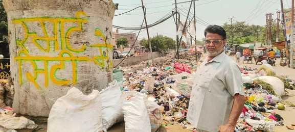 A pile of garbage near the Smart City slogan