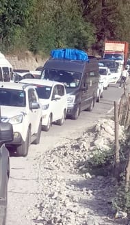 The narrow road is stopping the wheels of the tourist vehicle before it can pick up speed
