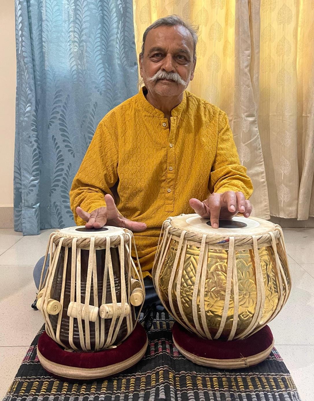 Aged fingers dancing on the tabla