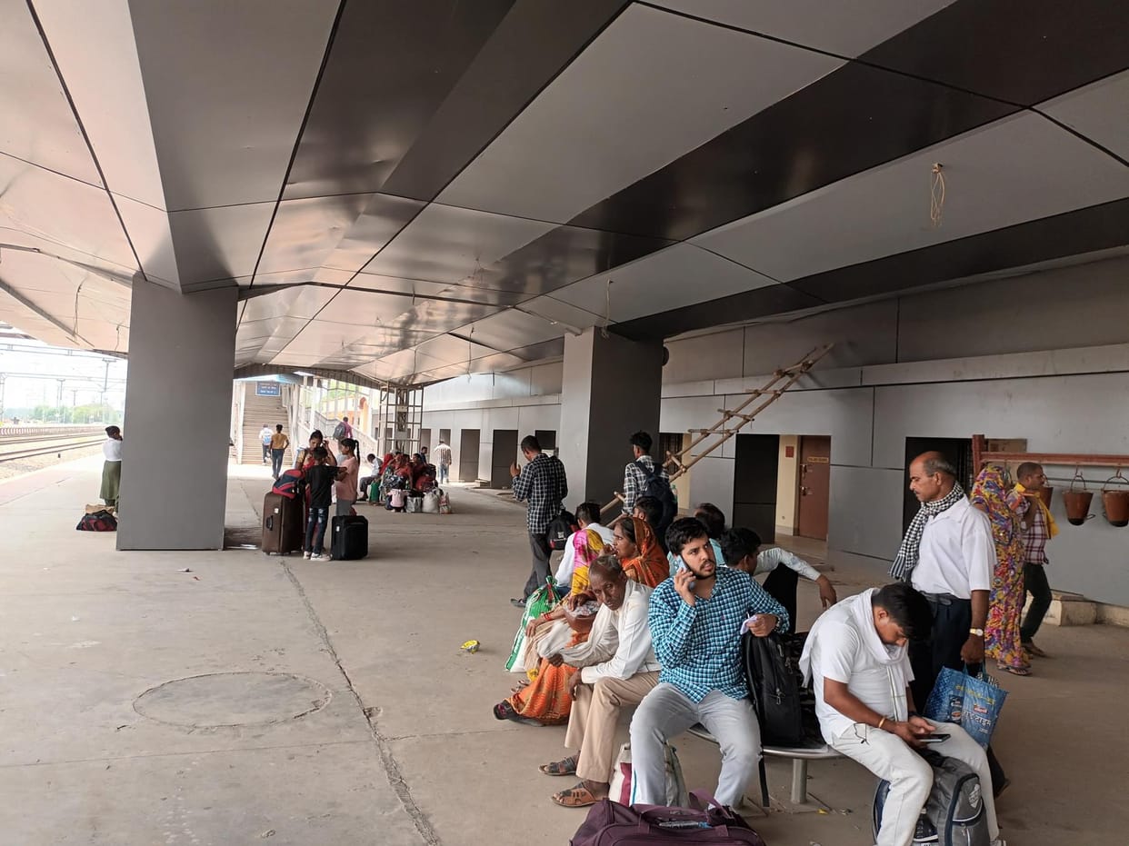 Railway passengers basking in the scorching sun